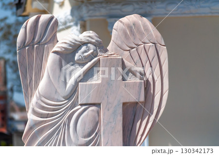 A statue watching over a grave 130342173