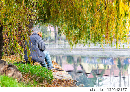 Man fishing on the riverbank Man fishing on the riverbank 130342177