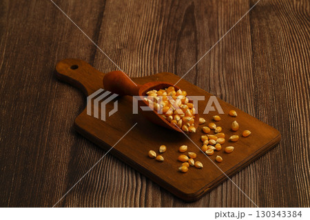 Corn seeds for popcorn isolated on dark rustic background. Copy space Corn seeds for popcorn isolated on dark rustic background. Copy space 130343384