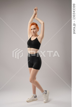 Woman expressing beauty in a nude, artistic light projection setting 130343399