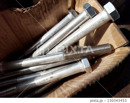 Box Containing Steel Bolts Ready for Use in Construction and Engineering Projects 130343453