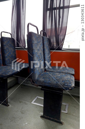 Seats Available on a Public Bus With Natural Light Streaming Through the Windows 130343611