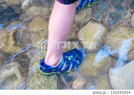Selective focus on submerged foot in water of a hiker in the Narrows in Zion National Park Selective focus on submerged foot in water of a hiker in the Narrows in Zion National Park 130343854