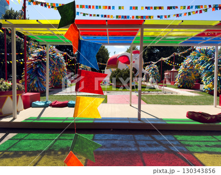 Vibrant installation with colorful flags, creative art objects and playful circus style elements making bright background for travel promotion, lifestyle blog or design project Vibrant installation with colorful flags, creative art objects and playful circus style elements making bright background for travel promotion, lifestyle blog or design project 130343856