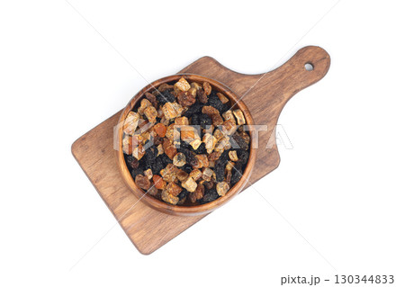 Mix of nuts and dried fruits in wooden bowl isolated on a white background. Mix of nuts and dried fruits in wooden bowl isolated on a white background. 130344833