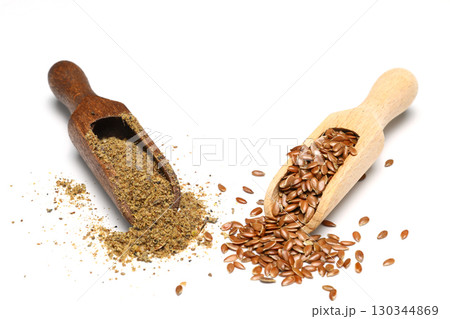 Flax seeds. Flaxseed powder in a wooden spoon. Standing on a white background. 130344869