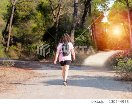 Woman choosing a path in a forest. Concept of decision making in life. Woman choosing a path in a forest. Concept of decision making in life. 130344958