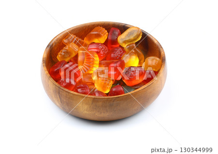 Colorful Jelly in a wooden bowl. isolated on white background Colorful Jelly in a wooden bowl. isolated on white background 130344999