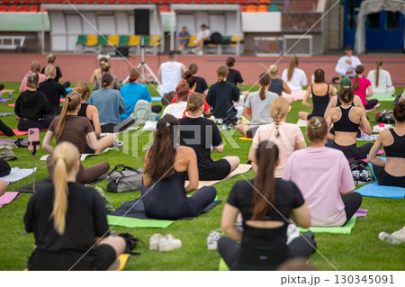 Group yoga session on stadium lawn in FYSM style 130345091