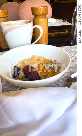 Bowl of cereals with almonds, dates, and pumpkin seeds creating nutritious breakfast in restaurant setting, accompanied by cappuccino , breakfast radiating wholesome energy. Bowl of cereals with almonds, dates, and pumpkin seeds creating nutritious breakfast in restaurant setting, accompanied by cappuccino , breakfast radiating wholesome energy. 130345850