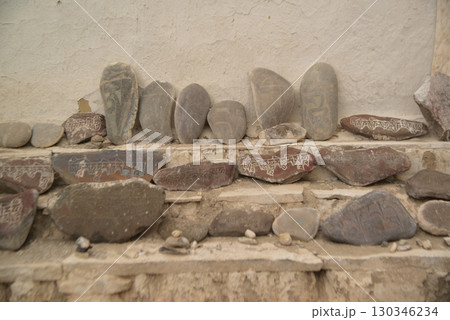 Sutra stones are placed along the walls of the Shey Palace in Leh, Ladakh, India. These stones are a cultural feature of China and Tibet. Buddhist scriptures inscribed on the stones express religious. Sutra stones are placed along the walls of the Shey Palace in Leh, Ladakh, India. These stones are a cultural feature of China and Tibet. Buddhist scriptures inscribed on the stones express religious. 130346234