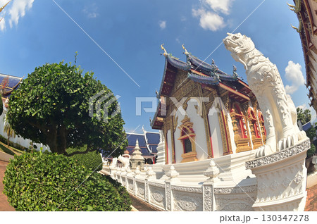 Statues of white Singha, which are animals in Thai art, decorate the front of the Church or Chapel at Wat Den Sali Si Mueang Kaen temple. Located at Chaing Mai Province in Thailand. Statues of white Singha, which are animals in Thai art, decorate the front of the Church or Chapel at Wat Den Sali Si Mueang Kaen temple. Located at Chaing Mai Province in Thailand. 130347278