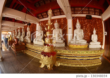 Row of indoor sitting white Buddha statue decoration in cloister at Wat Den Sali Si Mueang Kaen temple or Wat Ban Den. Located at Chiang Mai Province in Thailand. Row of indoor sitting white Buddha statue decoration in cloister at Wat Den Sali Si Mueang Kaen temple or Wat Ban Den. Located at Chiang Mai Province in Thailand. 130348034