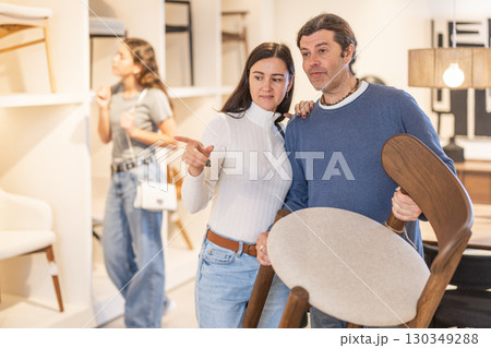 Man and woman choosing chair in furniture showroom 130349288