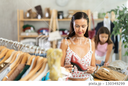Middle-aged woman choosing heels in clothing store Middle-aged woman choosing heels in clothing store 130349299