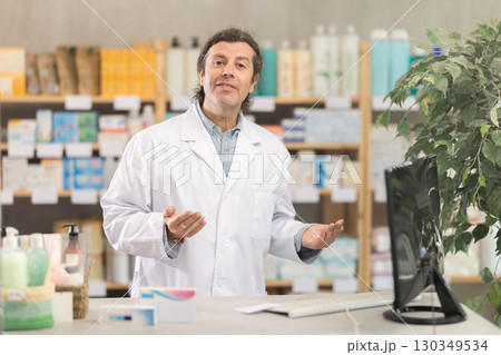 Adult male pharmacist invites to pharmacy Adult male pharmacist invites to pharmacy 130349534