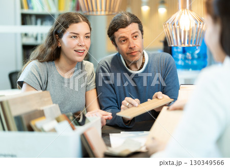 Man and woman choosing laminate flooring in the store Man and woman choosing laminate flooring in the store 130349566