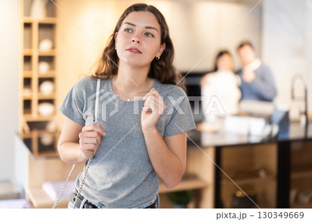 Young woman choosing decoration in furniture salon Young woman choosing decoration in furniture salon 130349669