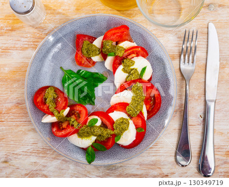 Caprese salad with tomatoes, mozzarella, basil, pesto Caprese salad with tomatoes, mozzarella, basil, pesto 130349719