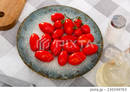 Plate full of cocktail cherry tomatoes on plate 130349763
