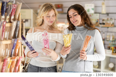 Two young women choosing incense sticks 130349800