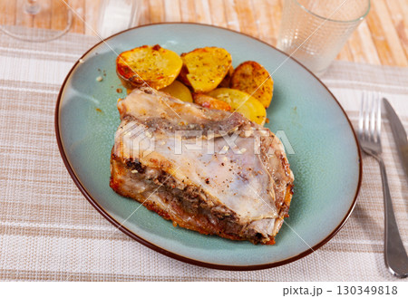 Roasted pork ribs with fried potatoes 130349818