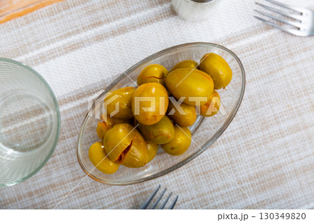 Bunch of green olives on table 130349820
