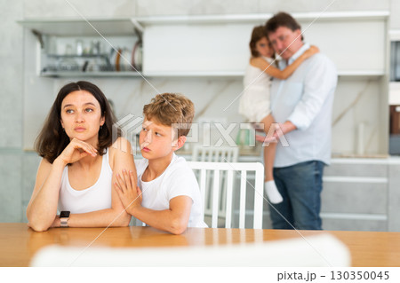 Family with two children in kitchen during quarrel Family with two children in kitchen during quarrel 130350045