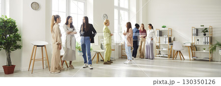 Group of diverse female business people working in office chatting after meeting Group of diverse female business people working in office chatting after meeting 130350126