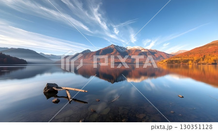fisherman on a lake in autumn morning 130351128