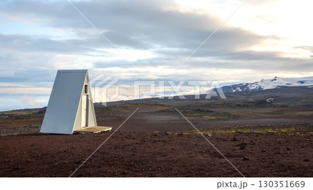 Unique A-frame structure in the expansive landscape of Iceland's rugged terrain 130351669