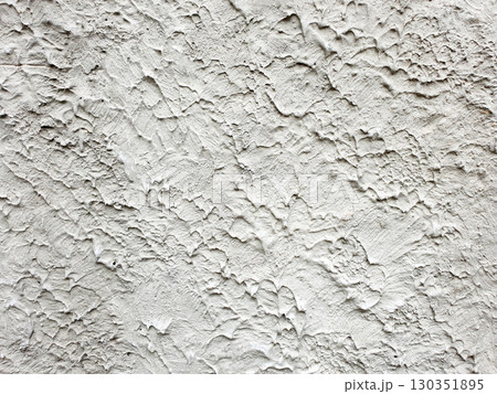 Textured white wall showcasing intricate patterns and variations in surface detail Textured white wall showcasing intricate patterns and variations in surface detail 130351895