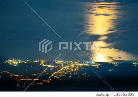 Nighttime view of coastal lights reflecting in the sea near Turkey's shoreline 130352039