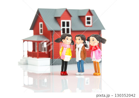 Miniature people interacting in front of a charming red house during a sunny day 130352042