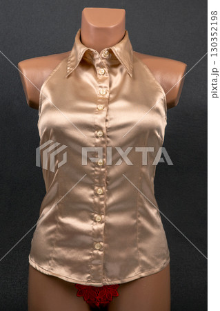 Elegant satin halter neck top showcased on a mannequin against a dark background 130352198