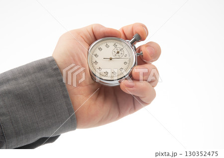 Stopwatch held in hand to measure time during an event or activity 130352475