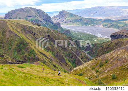 Hiking through the stunning landscapes of Iceland's valleys and hills 130352612