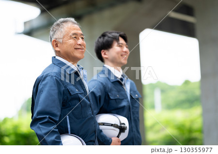 作業着姿の若手とベテラン 130355977