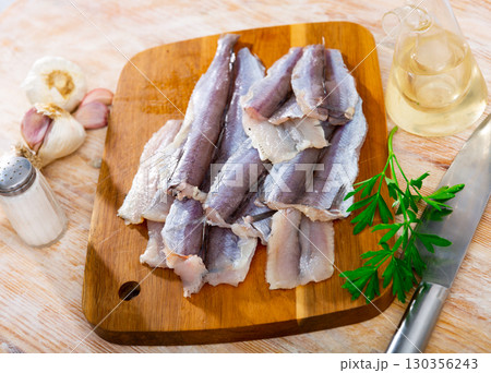 Raw blue whiting fillet ready for cooking Raw blue whiting fillet ready for cooking 130356243