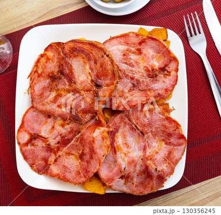 Sliced Galician lacon ham with paprika on plate Sliced Galician lacon ham with paprika on plate 130356245
