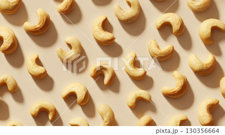 Cashew nut pattern with natural light and shadow on beige background, creating warm and appetizing food texture scene 130356664
