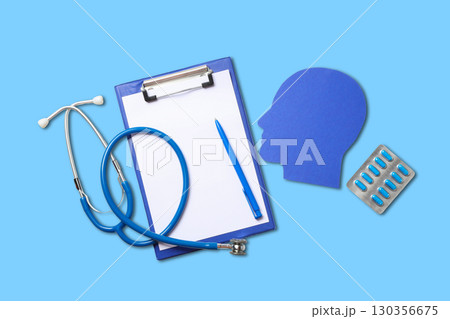 Clipboard with notes stethoscope and medication on a blue background Clipboard with notes stethoscope and medication on a blue background 130356675