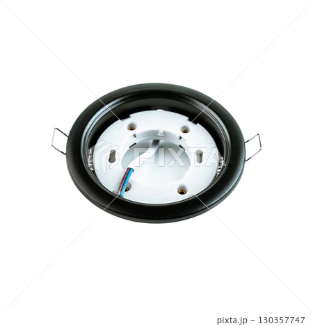 Round black metal recessed ceiling light fixture frame for spotlights, used for mounting lamps in a stretch ceiling and lighting equipment store. Round black metal recessed ceiling light fixture frame for spotlights, used for mounting lamps in a stretch ceiling and lighting equipment store. 130357747
