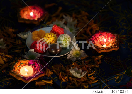 Diwali Festivities: Traditional Sweets and Diyas on Table 130358856