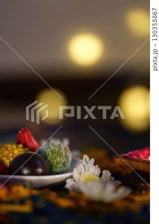 Diwali Delight: Traditional Sweets Surrounded by Diyas 130358867