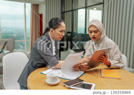 Collaborative business meeting with professionals in a modern workspace 130358969