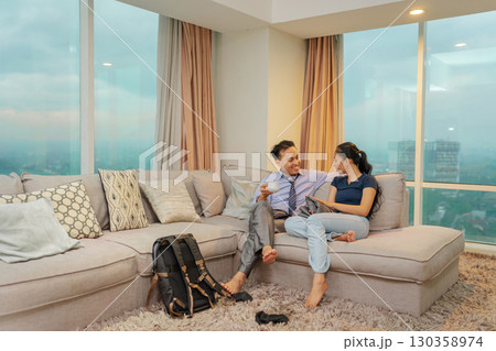 Casual conversation taking place in a modern living room featuring a stunning city view Casual conversation taking place in a modern living room featuring a stunning city view 130358974