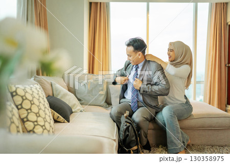 A couple happily prepares for an exciting event in a stylish living room A couple happily prepares for an exciting event in a stylish living room 130358975