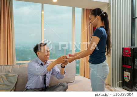 A Romantic Engagement Moment shared between a Couple in a Contemporary Setting A Romantic Engagement Moment shared between a Couple in a Contemporary Setting 130359004