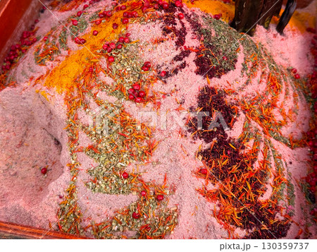 Colorful spice blend with red berries, saffron, and herbs at a market stall. Exotic culinary traditions, gastronomy, and food culture. Colorful spice blend with red berries, saffron, and herbs at a market stall. Exotic culinary traditions, gastronomy, and food culture. 130359737